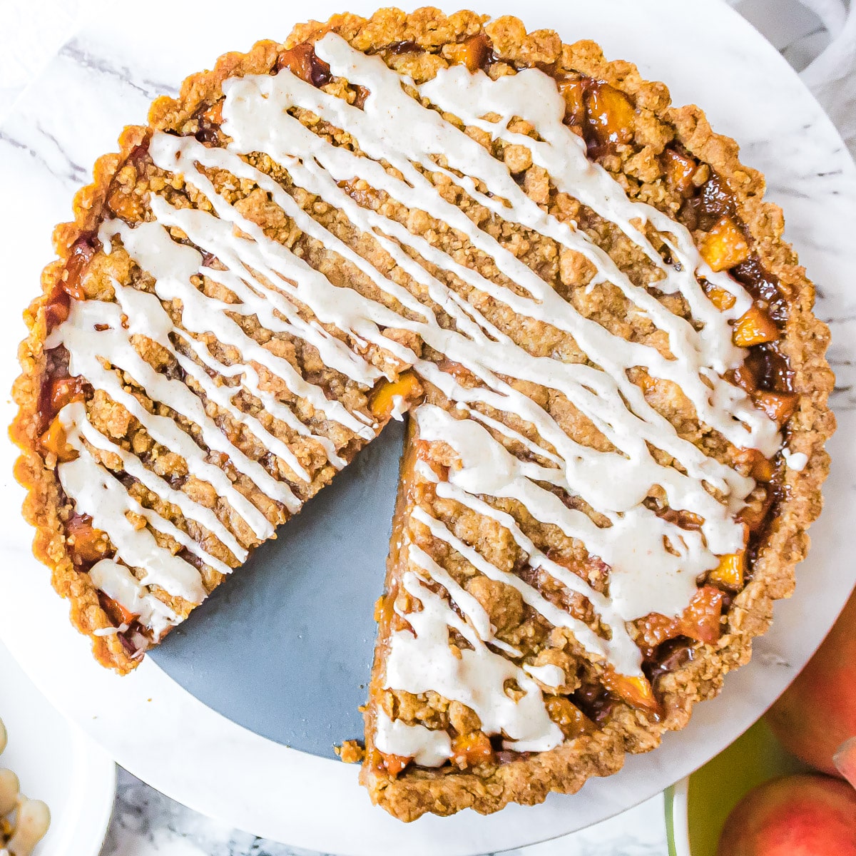 brown butter peach tart from above with a slice cut out