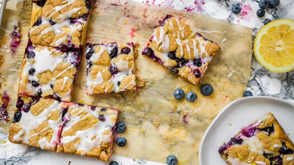 8-Ingredient Blueberry Lemon Cheesecake Bars Recipe with Sugar Cookie Crust and Lemon Icing | Chenée Today