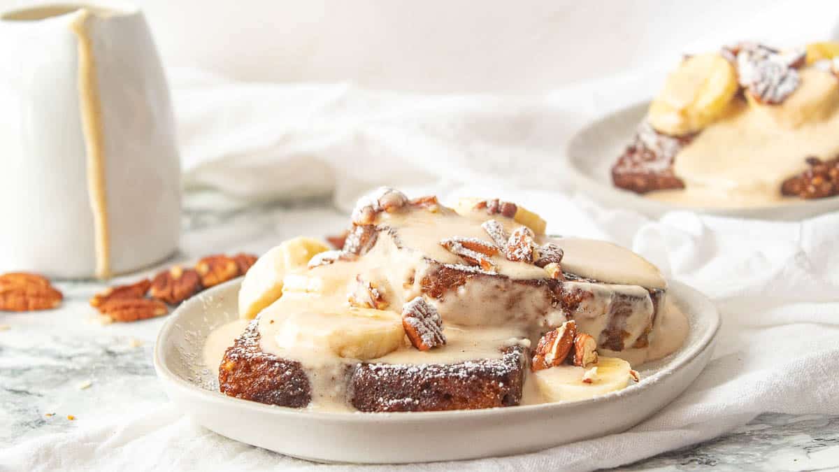 banana bread french toast on a plate with cream cheese glaze