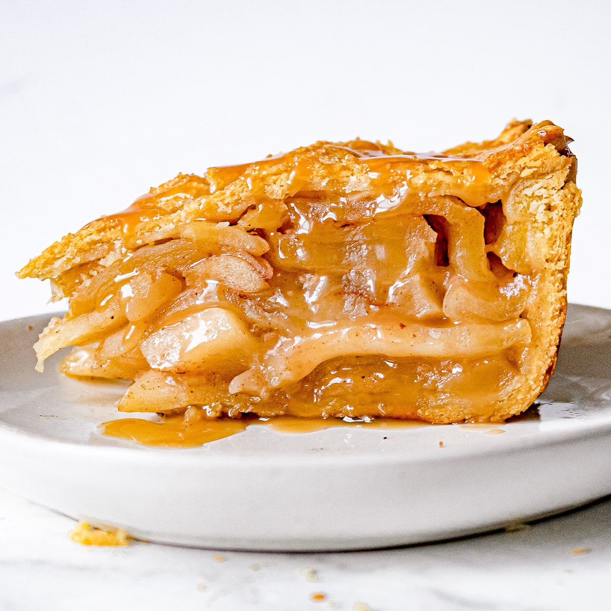 Side view of slice of deep dish caramel apple pie