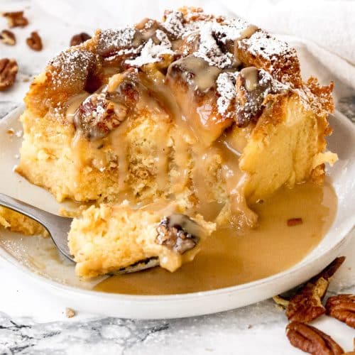 eggnog bread pudding on a plate with rum glaze