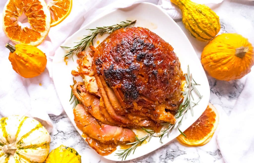 Overhead view of pressure cooker ham with gourds and dehydrated oranges