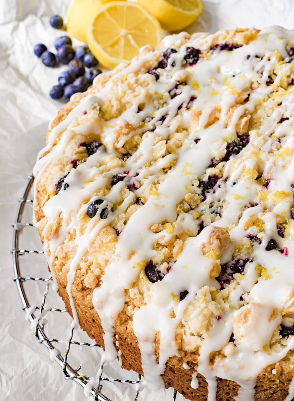iced cream cheese blueberry cake on a rack