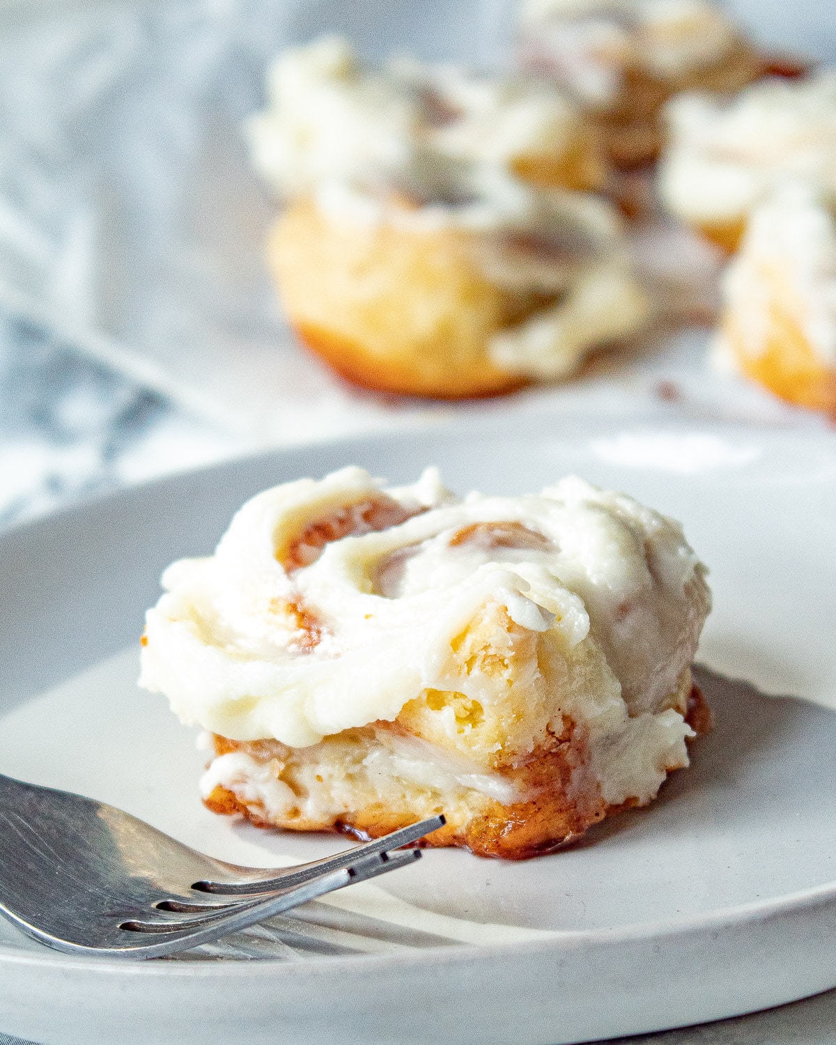 puff pastry cinnamon rolls on a plate with a fork