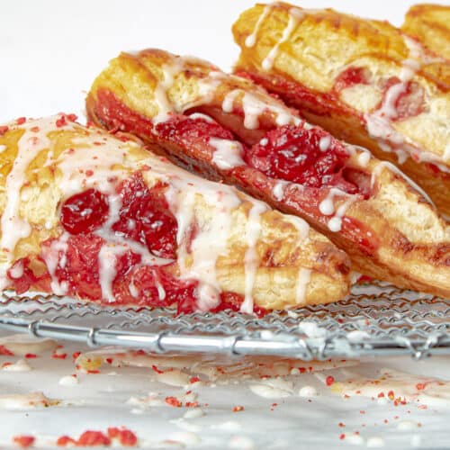 iced strawberry turnovers on a rack