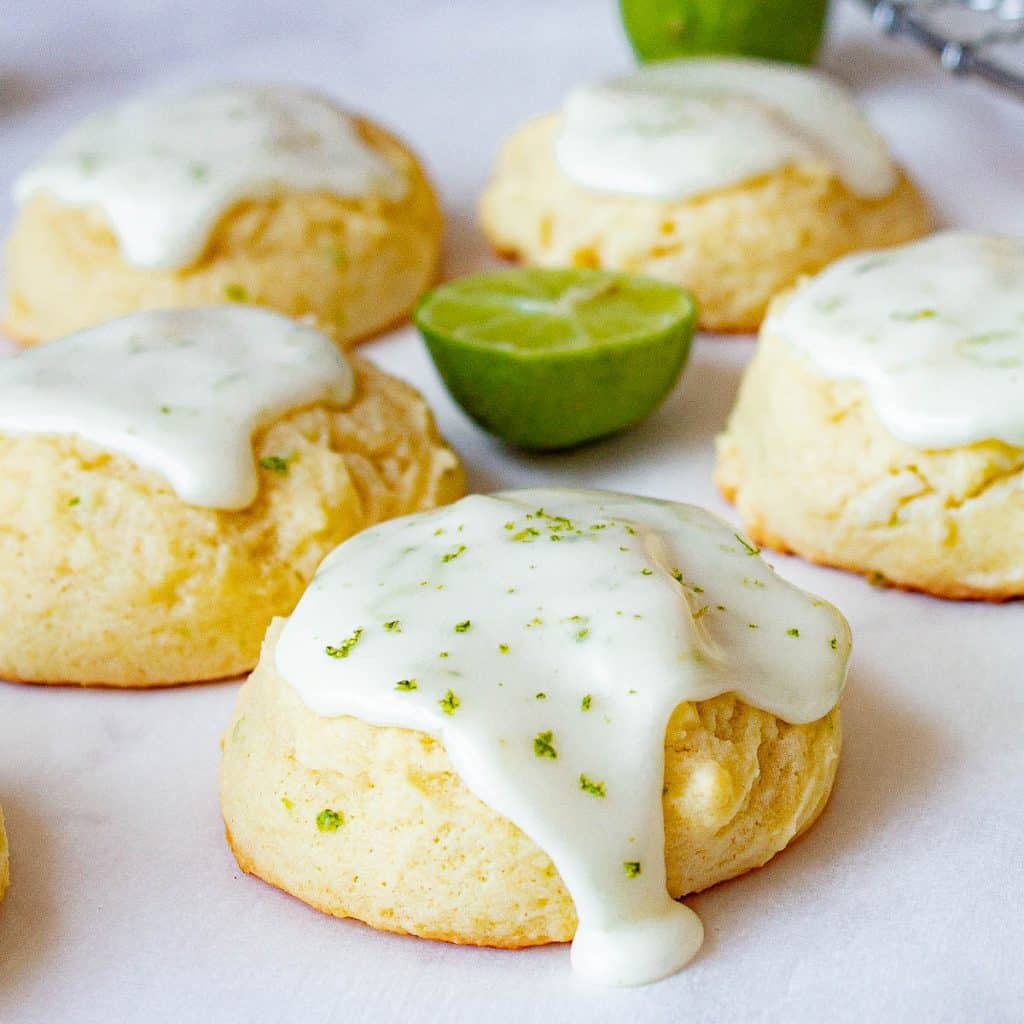 Glazed key lime cookies on parchment paper