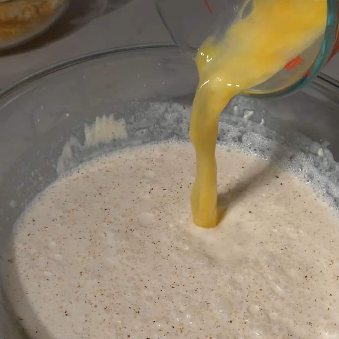 Adding egg to southern baked mac and cheese recipe.