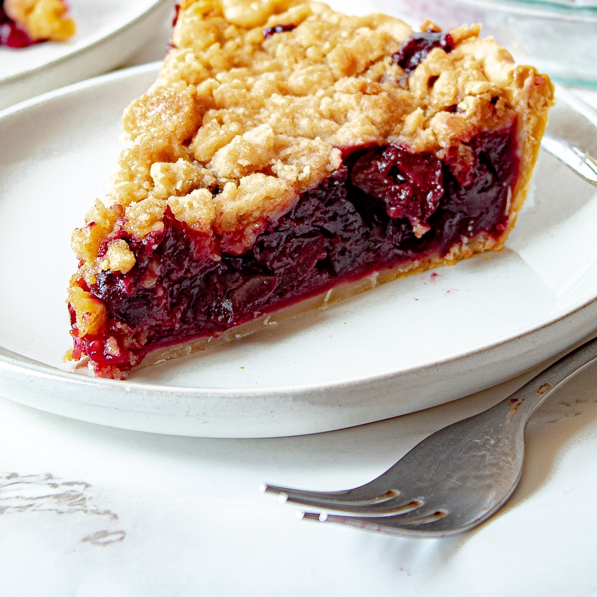cherry crumb pie on a plate
