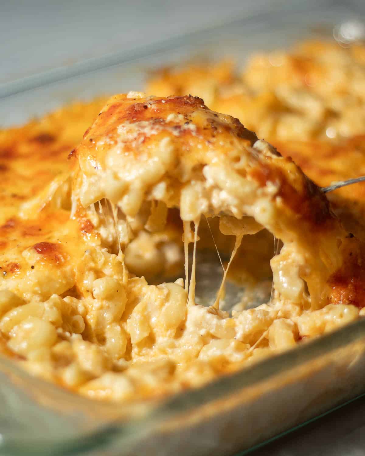 Spoon scooping southern baked mac and cheese.