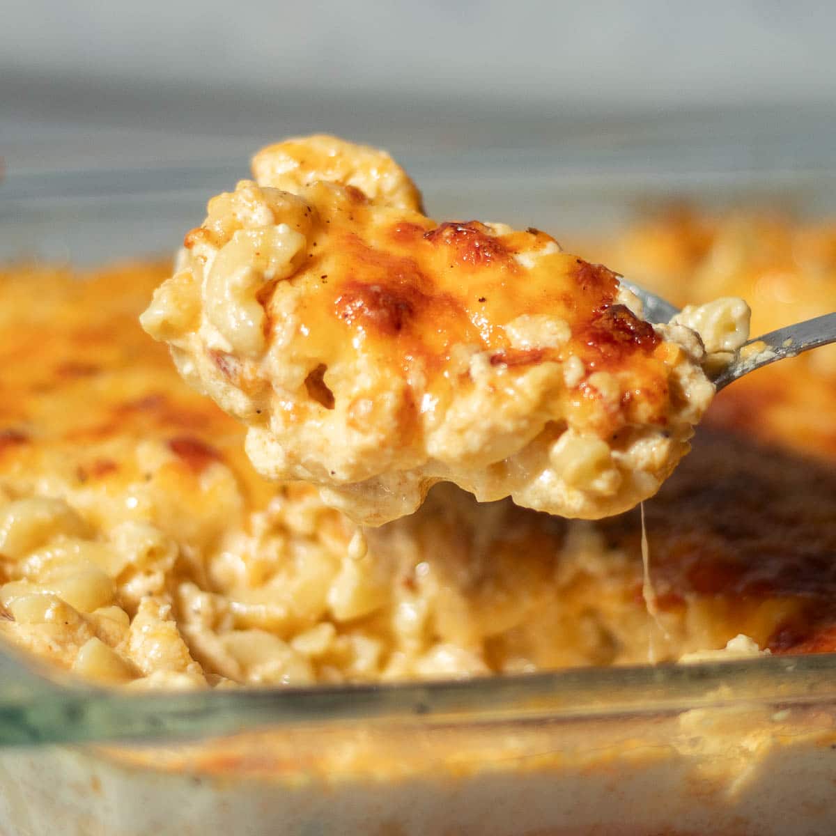 Spoon scooping southern baked mac and cheese.