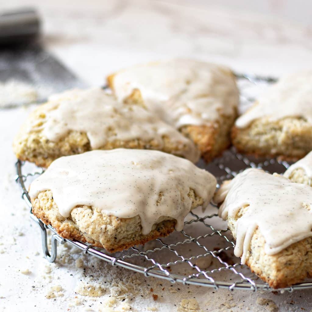 Earl Grey Scones on a wire rack drizzled with vanilla bean glaze