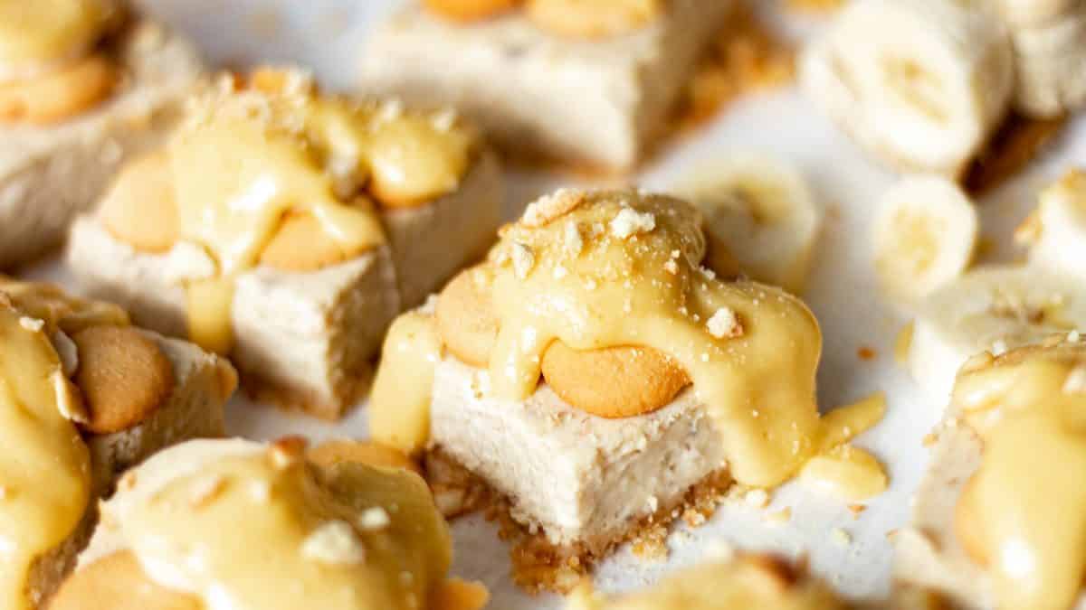 banana cream cheesecake bars with Nilla wafers on parchment paper
