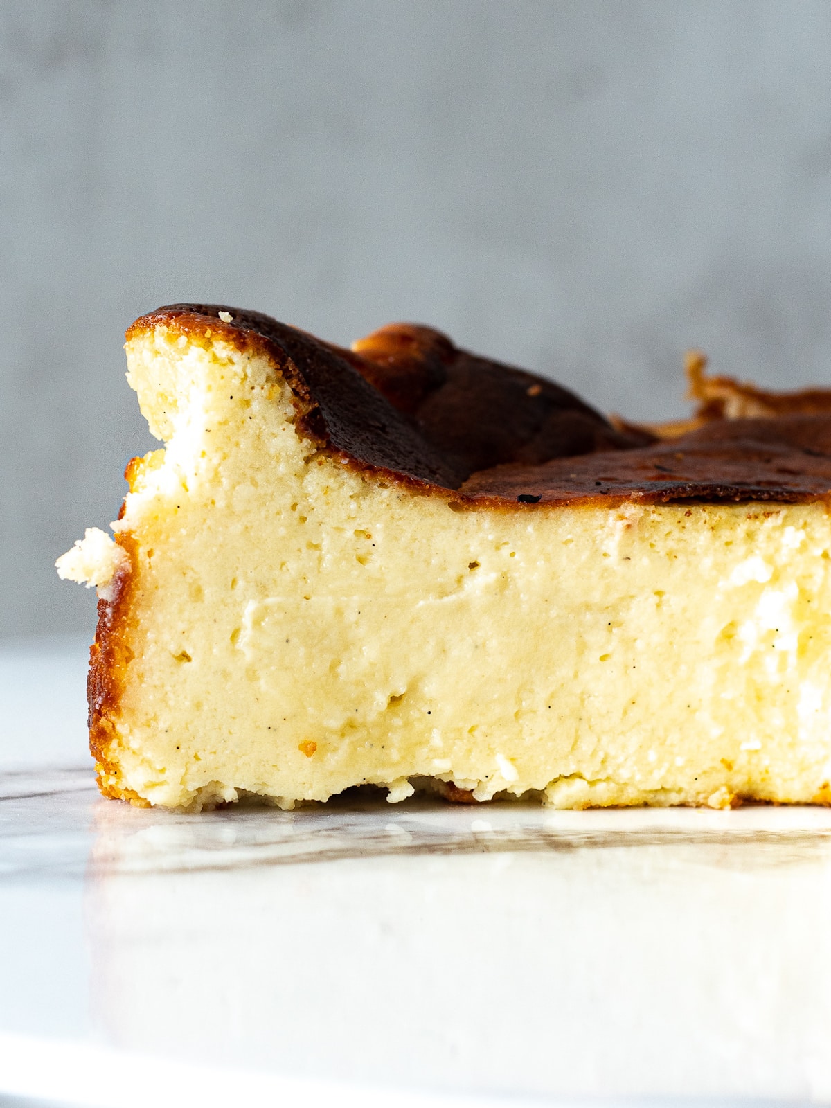 Side view of slice of mini basque cheesecake