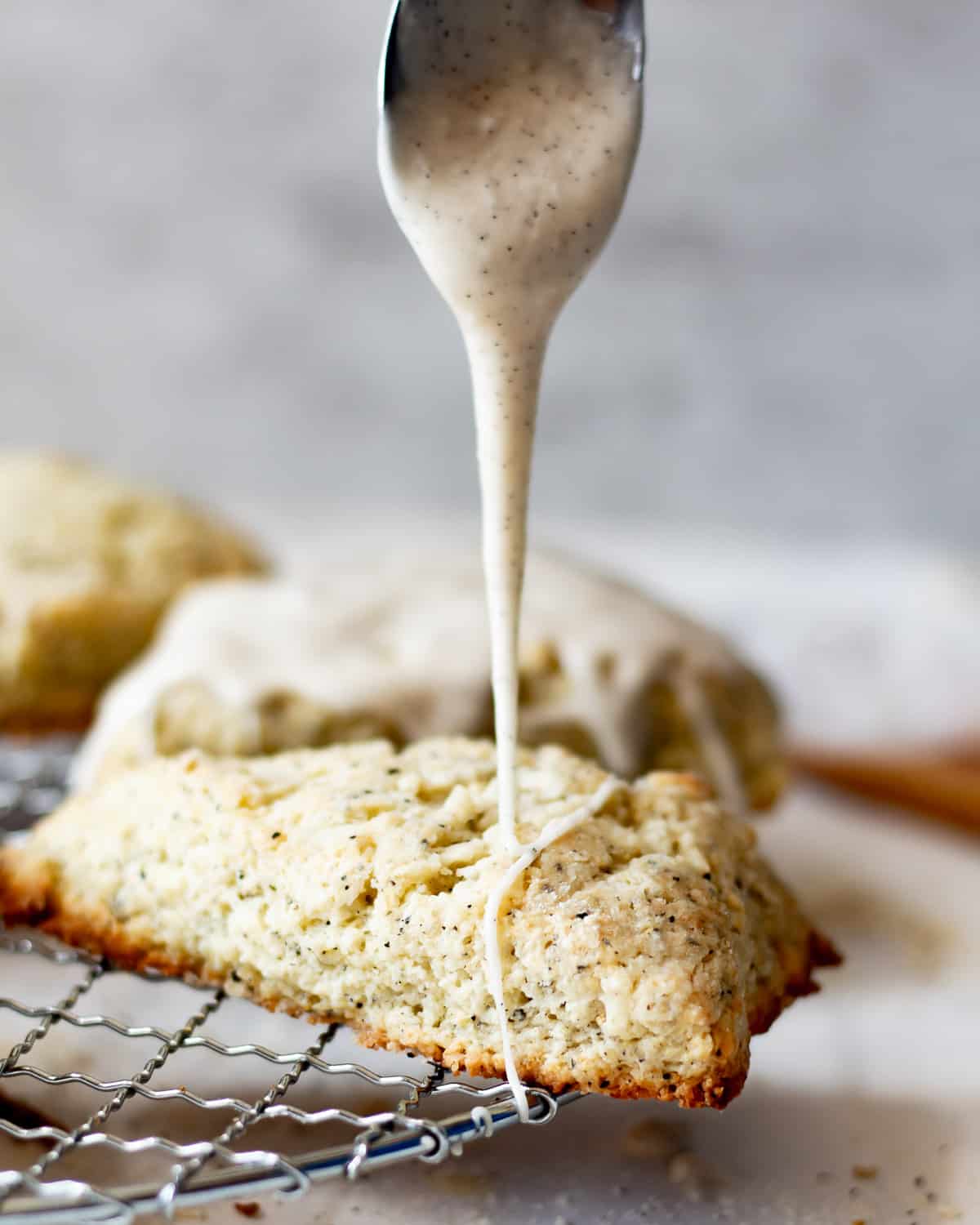 Earl Grey Scones on a wire rack drizzled with vanilla bean glaze
