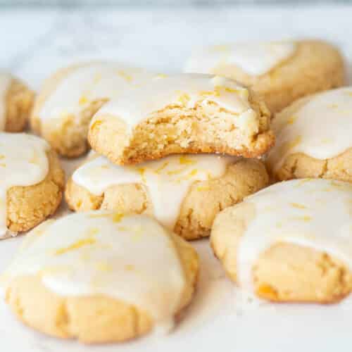 almond lemon cookies stacked on a plate
