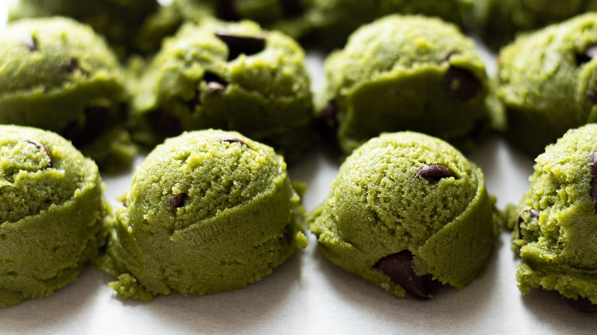 scoops of raw matcha chocolate chip cookies dough
