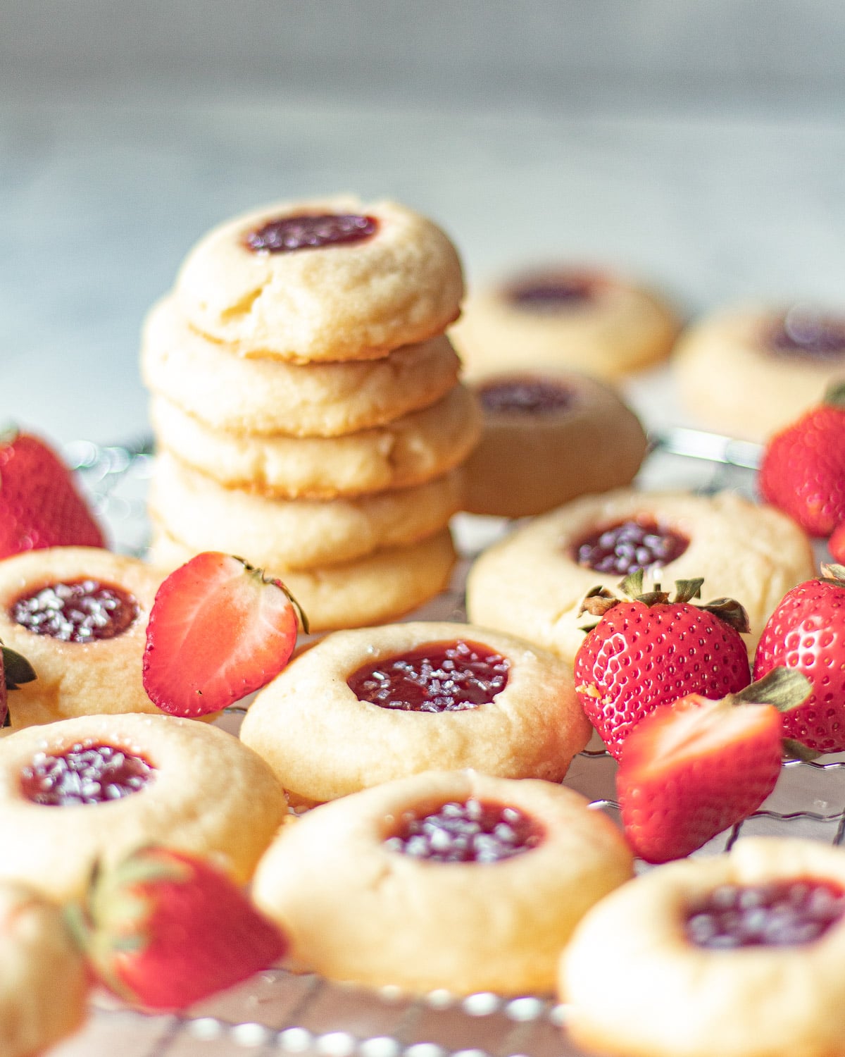 Strawberry cookies stacked on a wire rack