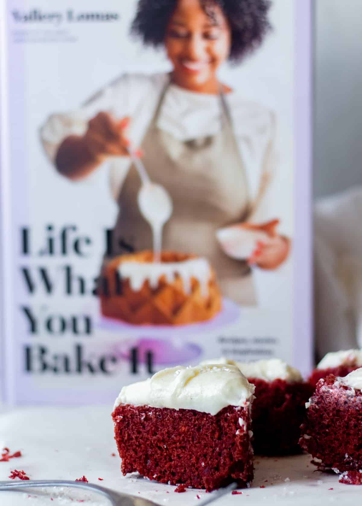 mini red velvet cake with cookbook in the background