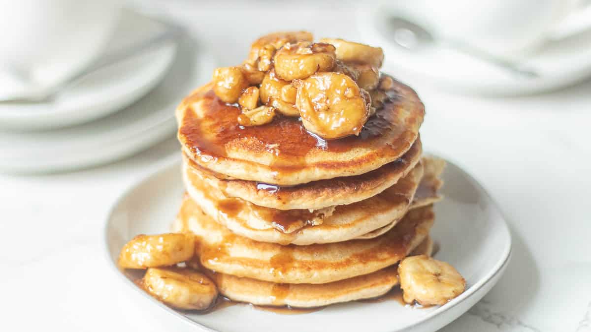 bananas foster pancakes recipe stacked on a plate