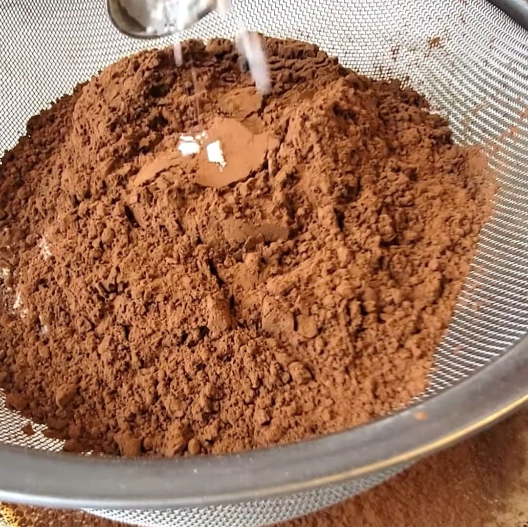 Sifting dry ingredients for brownies with condensed milk.