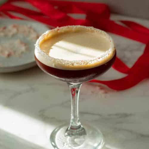 peppermint espresso martini with peppermint candy on the rim