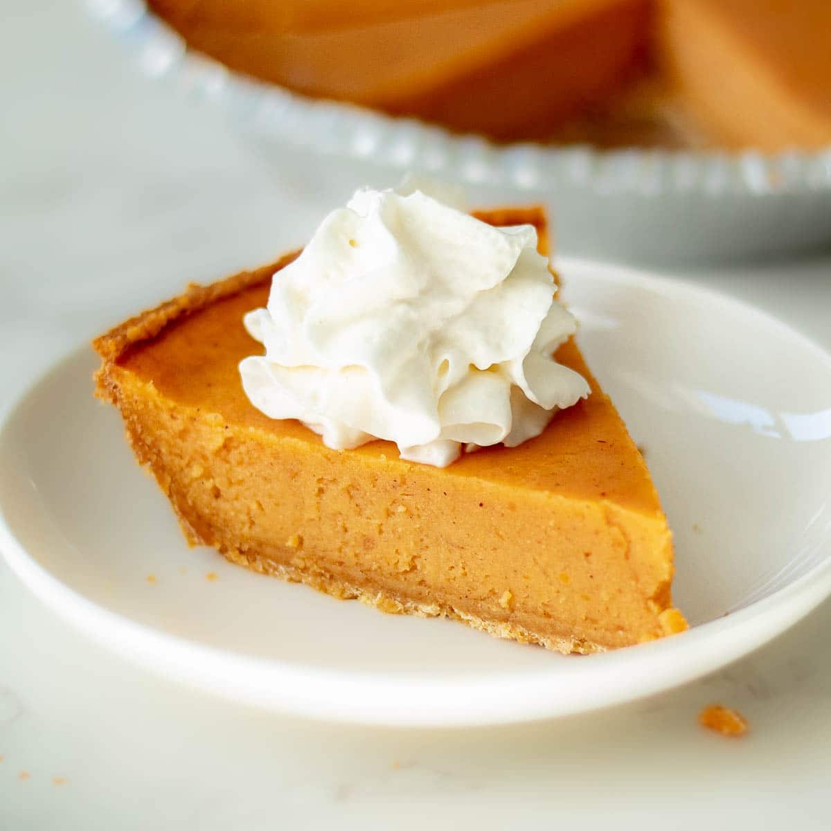 sweet potato pie with graham cracker crust on a plate