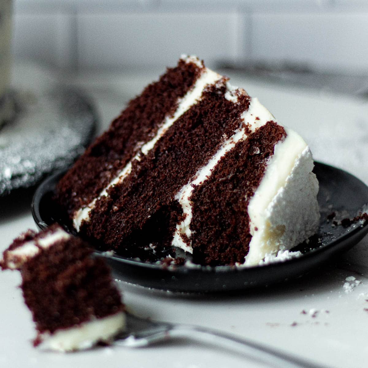 chocolate cake with cream cheese frosting on a plate
