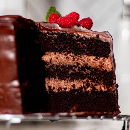 Close-up of chocolate mousse cake slice highlighting airy mousse filling and soft chocolate cake layers, a smooth and decadent chocolate dessert.