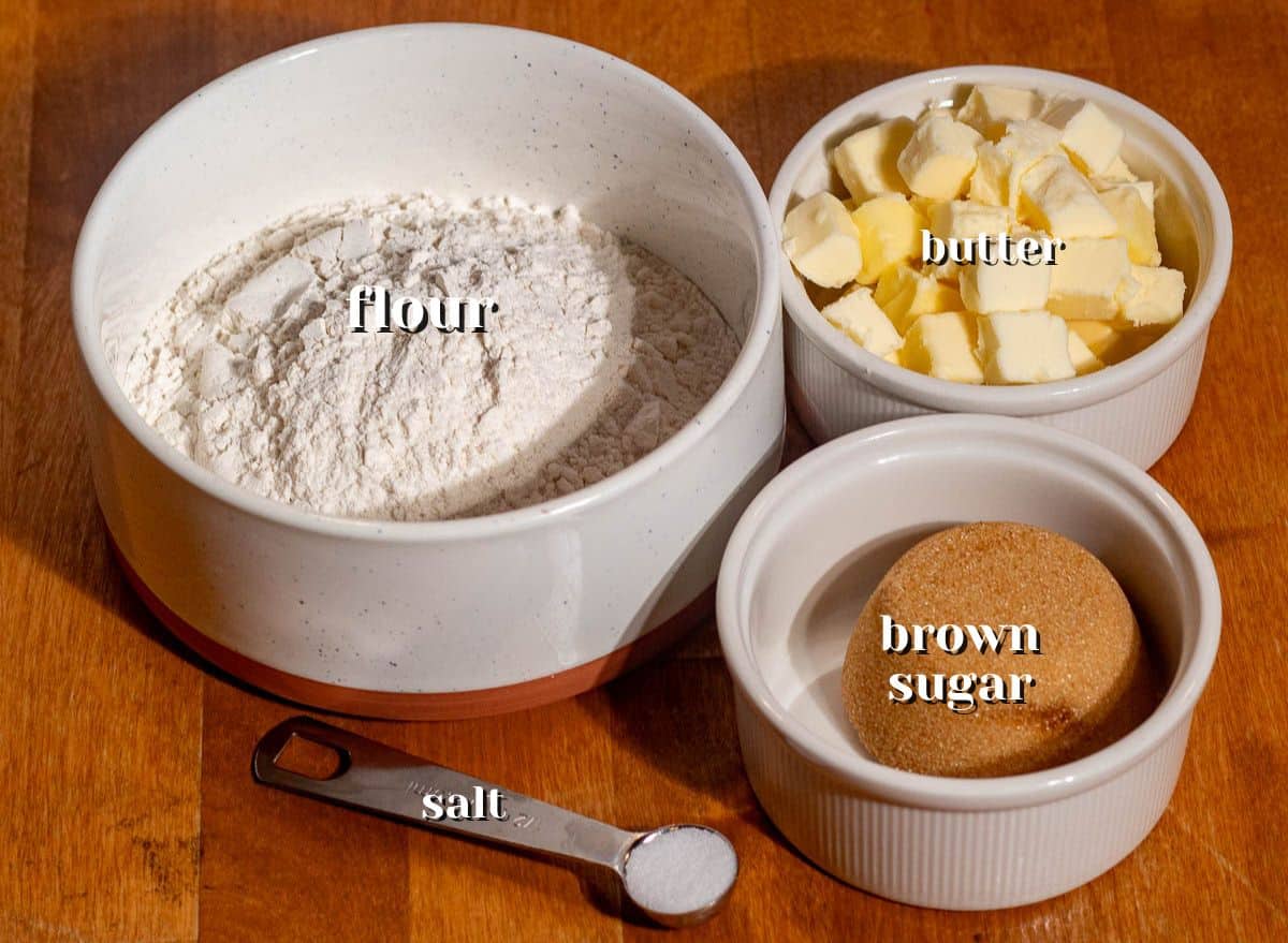 Measured flour, brown sugar, butter, and salt prepared to make the buttery crust for easy chocolate pecan bars.