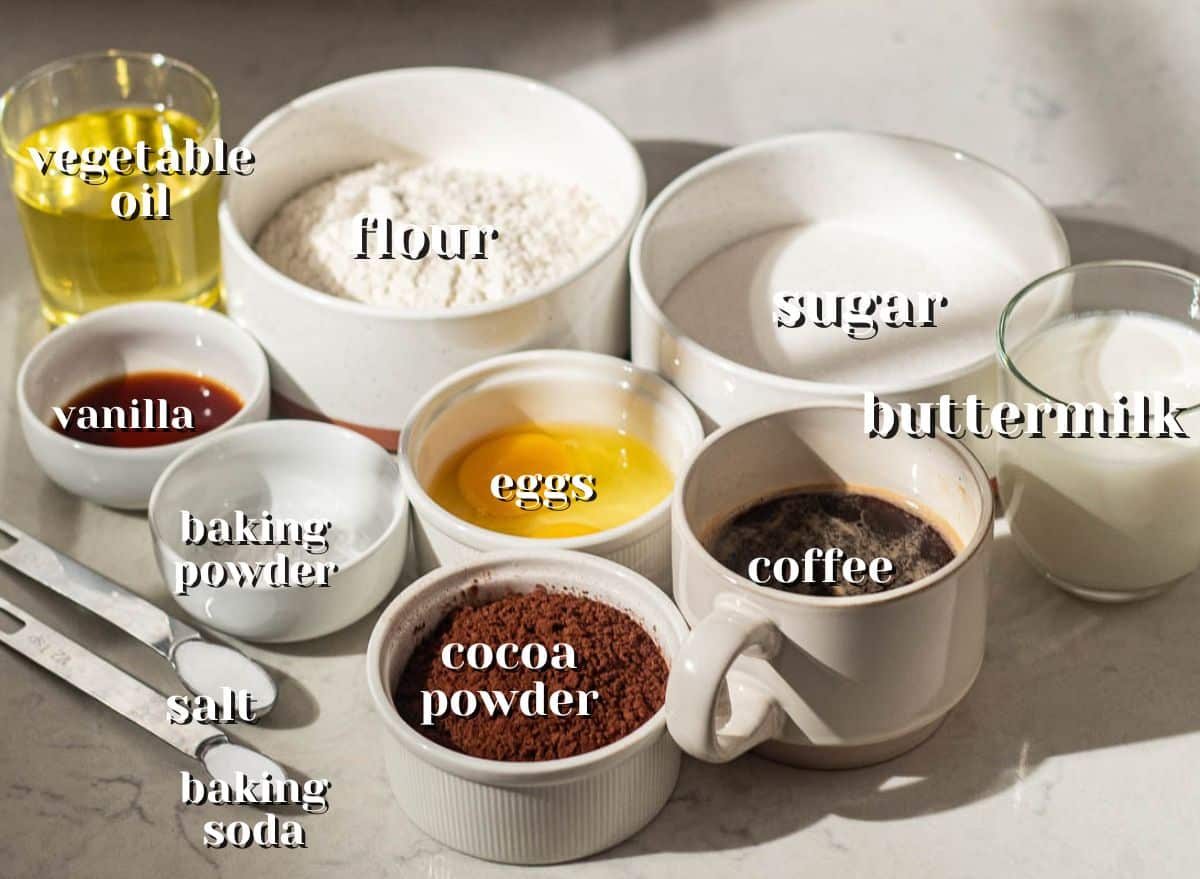 Baking ingredients for chocolate cake layers, featuring flour, sugar, cocoa powder, buttermilk, coffee, and eggs, used in an easy chocolate cake with chocolate mousse recipe.