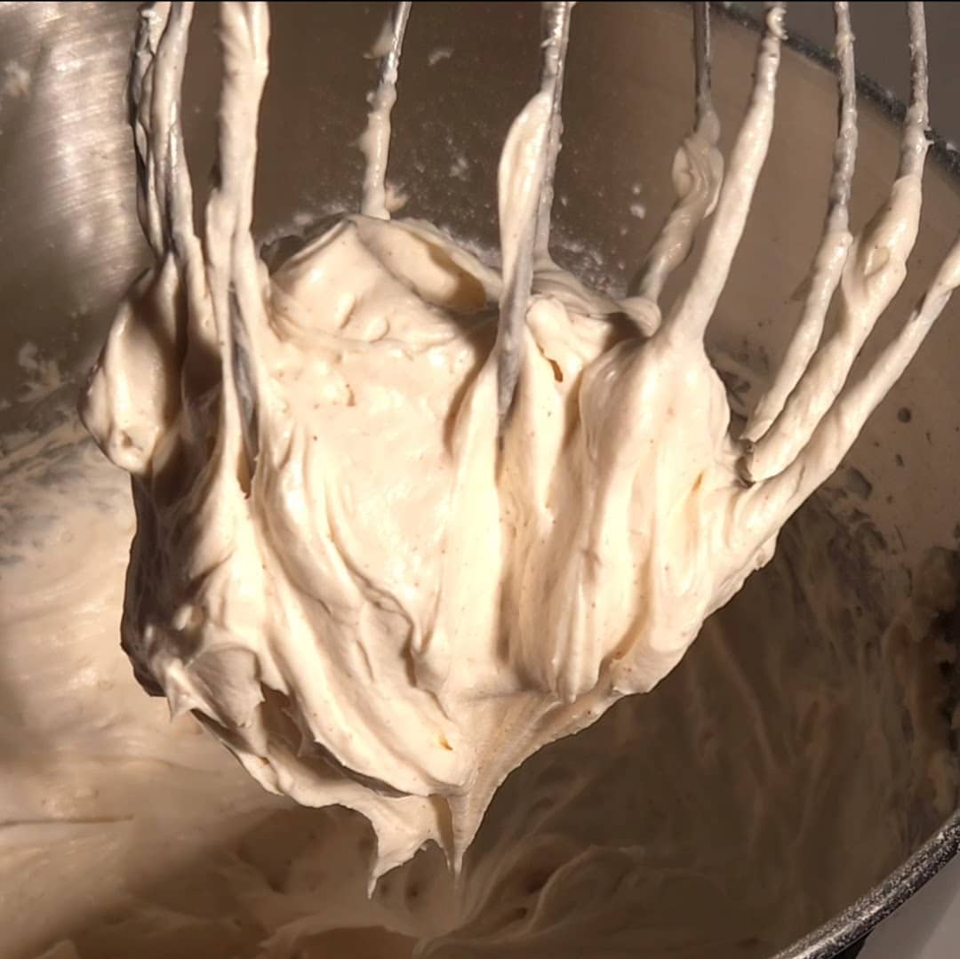 Browned butter cream cheese frosting whipped in a mixing bowl showing thick fluffy frosting ready for cakes and cupcakes.